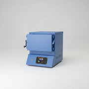 Blue kiln with open door on a white background